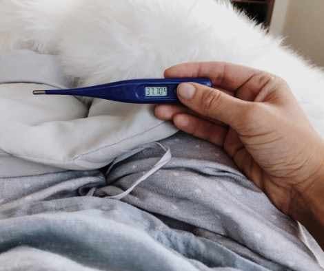 Checking temperature with a thermometer
